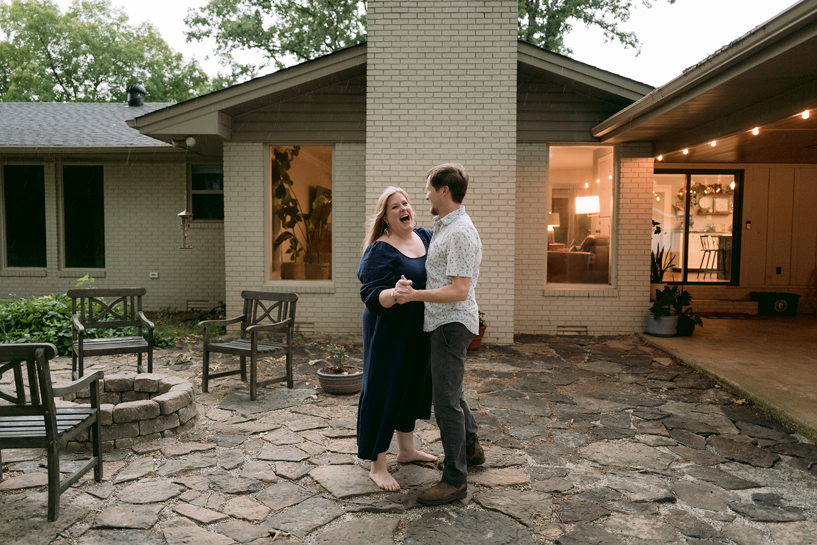 Married couple dances in the rain right outside of their home in Searcy, Arkansas.