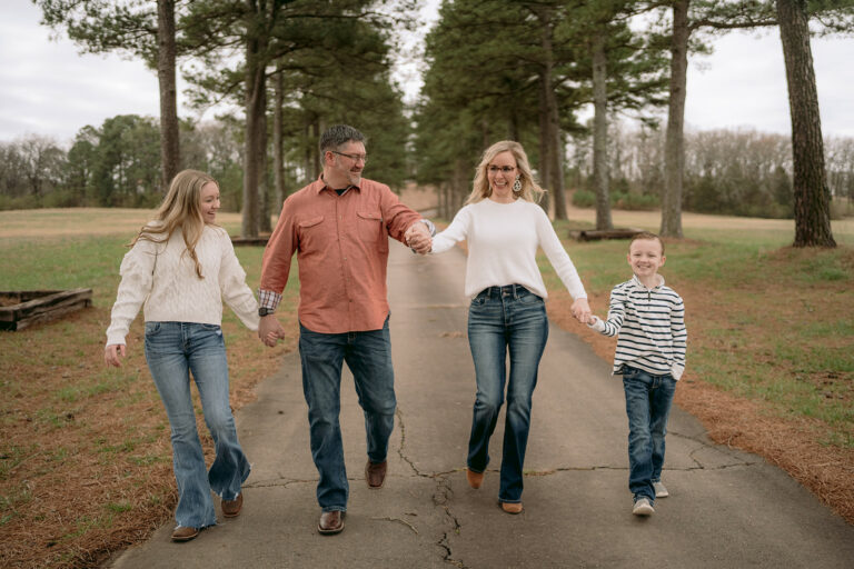 Family having fun while taking photos on an overcast day in Searcy.